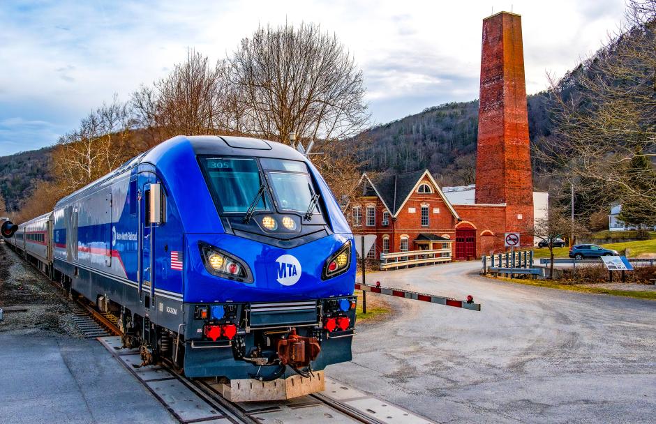 On the evening of March 30, 2026, Metro-North Railroad Siemens SC-42DM No. 305 leads Wassaic Train 943 past the former Borden’s Condensed Milk Factory in Wassaic, New York, where today’s upper Harlem Line quietly echoes the milk trains that once served the valley’s farming communities.