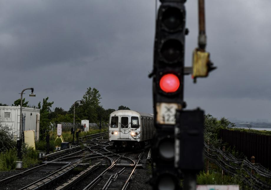 An MTA shuttle train runs during a storm. 