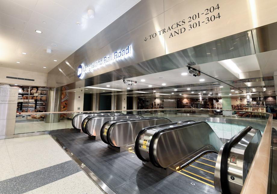 An escalator bank in a train station with four escalators