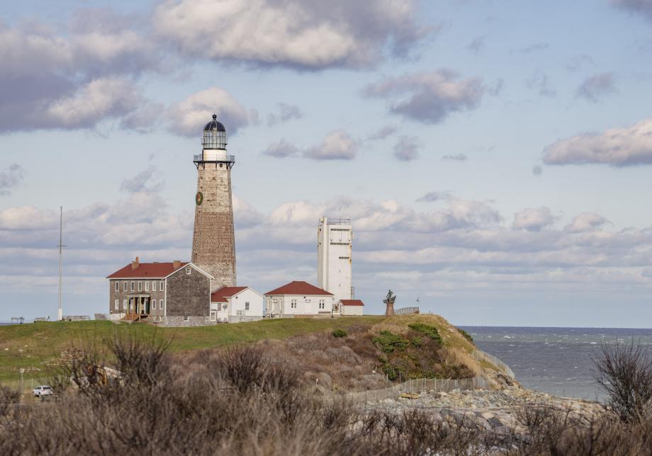 A lighthouse situated on a bluff. 