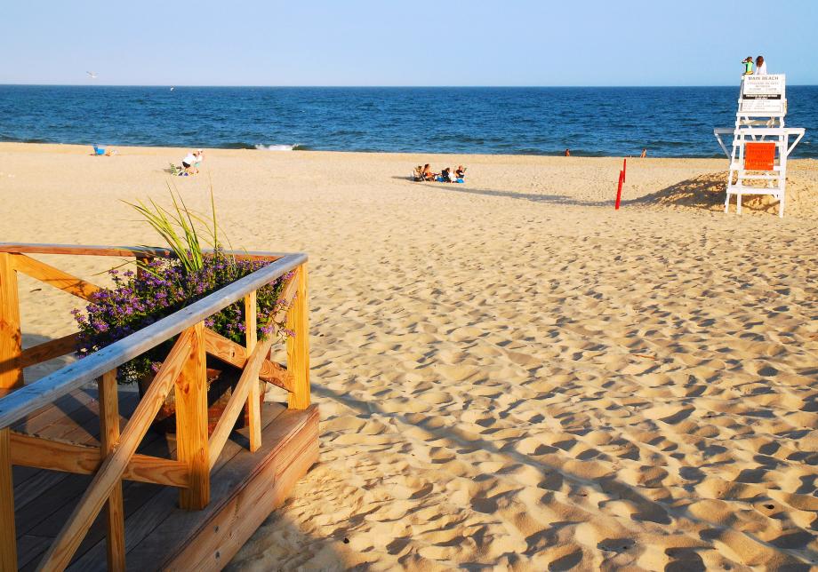 A beach with people hanging out in the afternoon. 