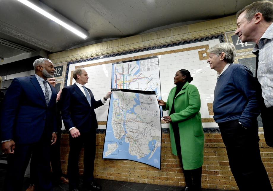 MTA executive leadership unveils a new subway diagram in a subway station. 