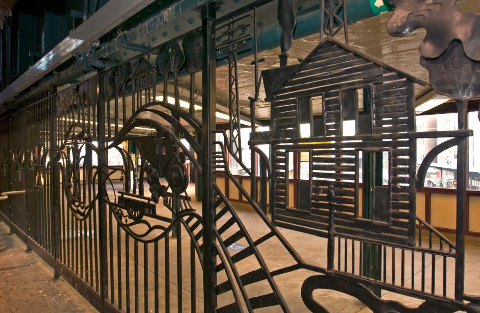 Artwork in metal by Dimitri Gerakaris showing abstract forms of a railroad, trains and houses.