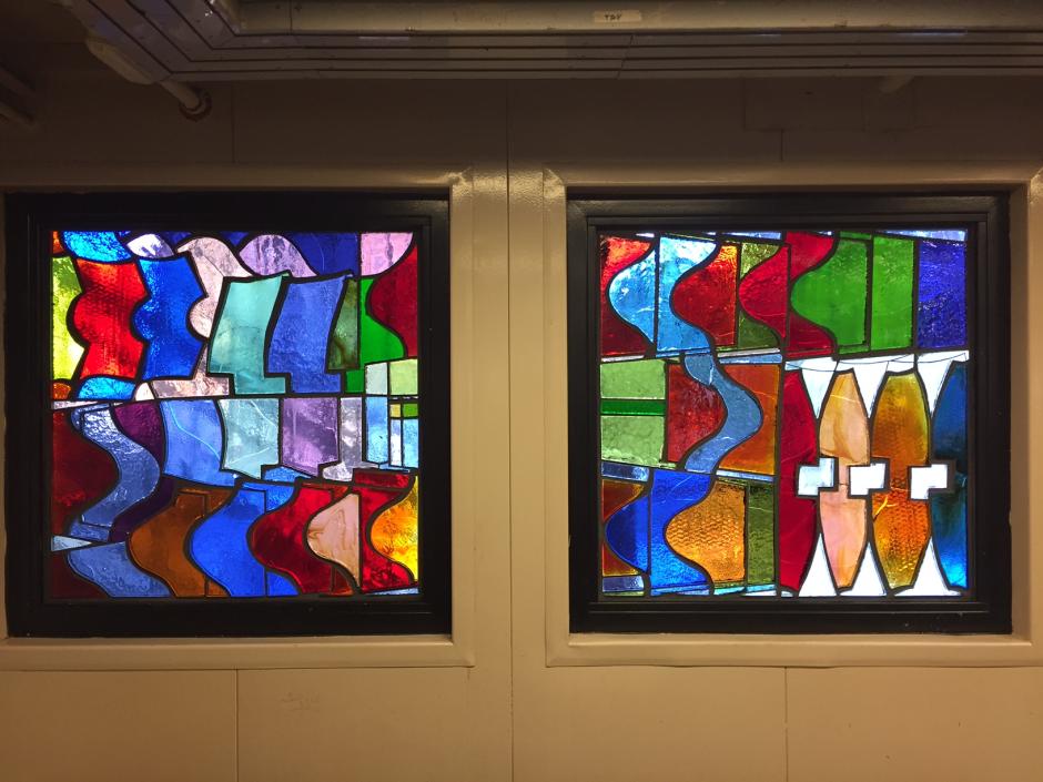 Artwork in faceted glass by Mara Held showing colorful geometric patterns and overlapping forms. 