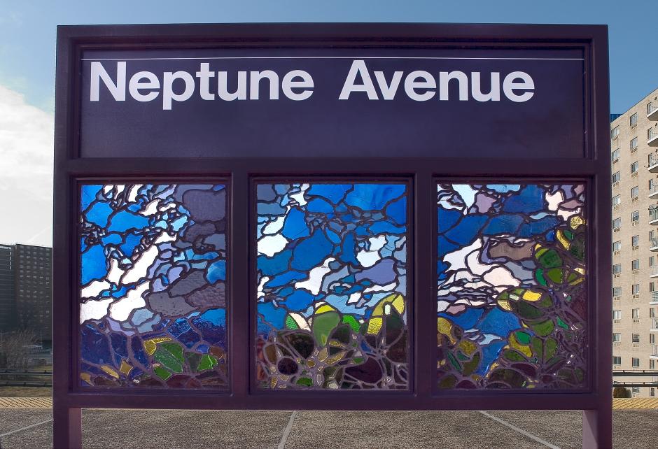 Artwork in faceted glass by Michael Krondl showing images representing Coney Island like trees and a roller Coaster in the platform windscreens. 