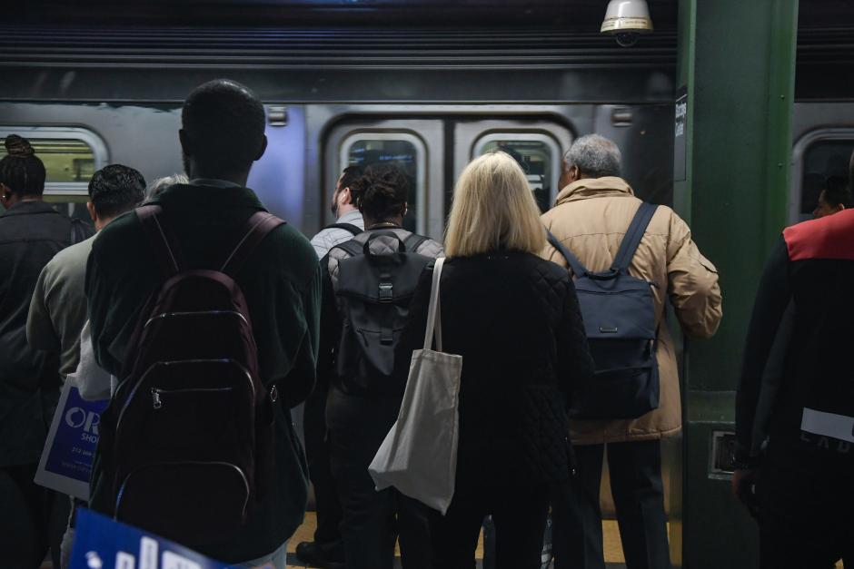 Riders waiting to board a train on a crowded platform at Atlantic Av-Barclays Center subway station