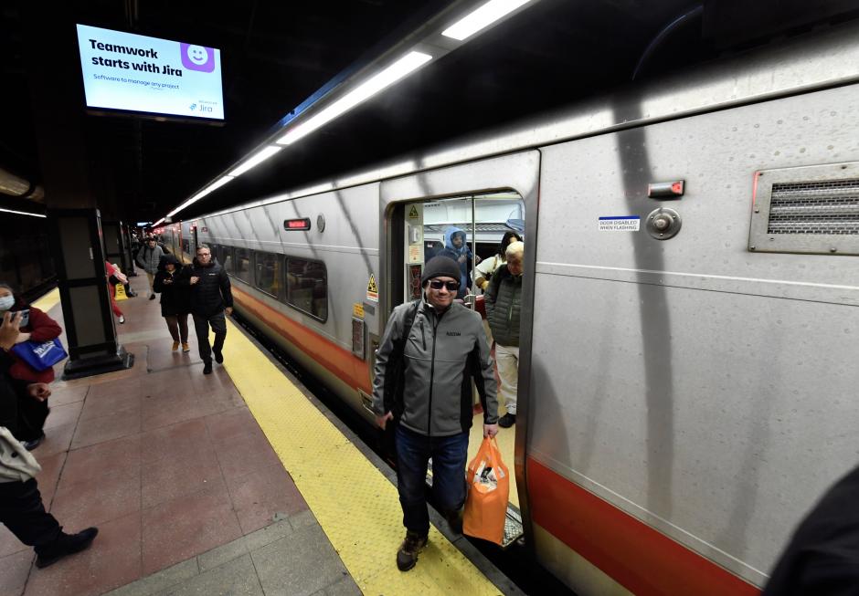 Riders exiting a New Haven Line train at a platform at Grand Central