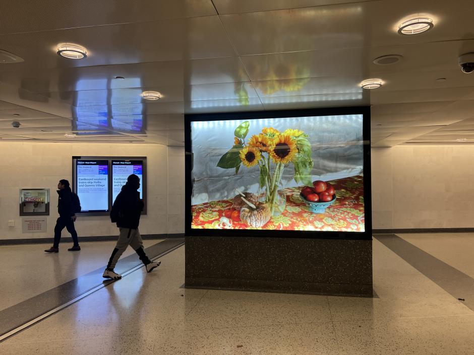 View of photography lightbox in a station with an image of a sunflower on a table.