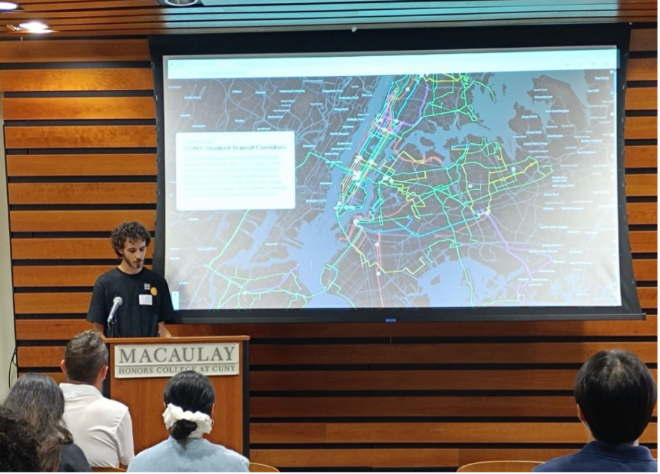 Jonah Moskal standing at a lectern presenting his website on a screen behind him