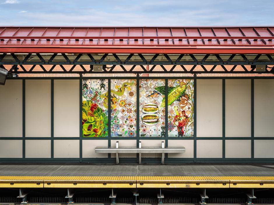 Glass artwork in station windscreens depicting a collage of plants and foods.