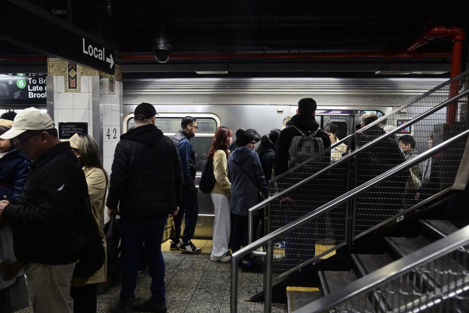 Riders on the platform boarding a 6 train at Grand Central Station