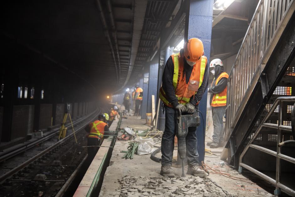 Contractors doing construction work on a subway platform