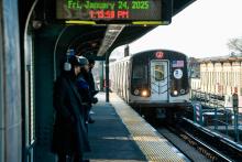 J train at Woodhaven Blvd station on a sunny winter day