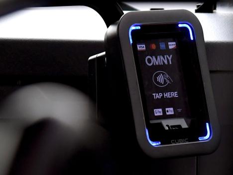 A close-up of an OMNY reader on a bus.